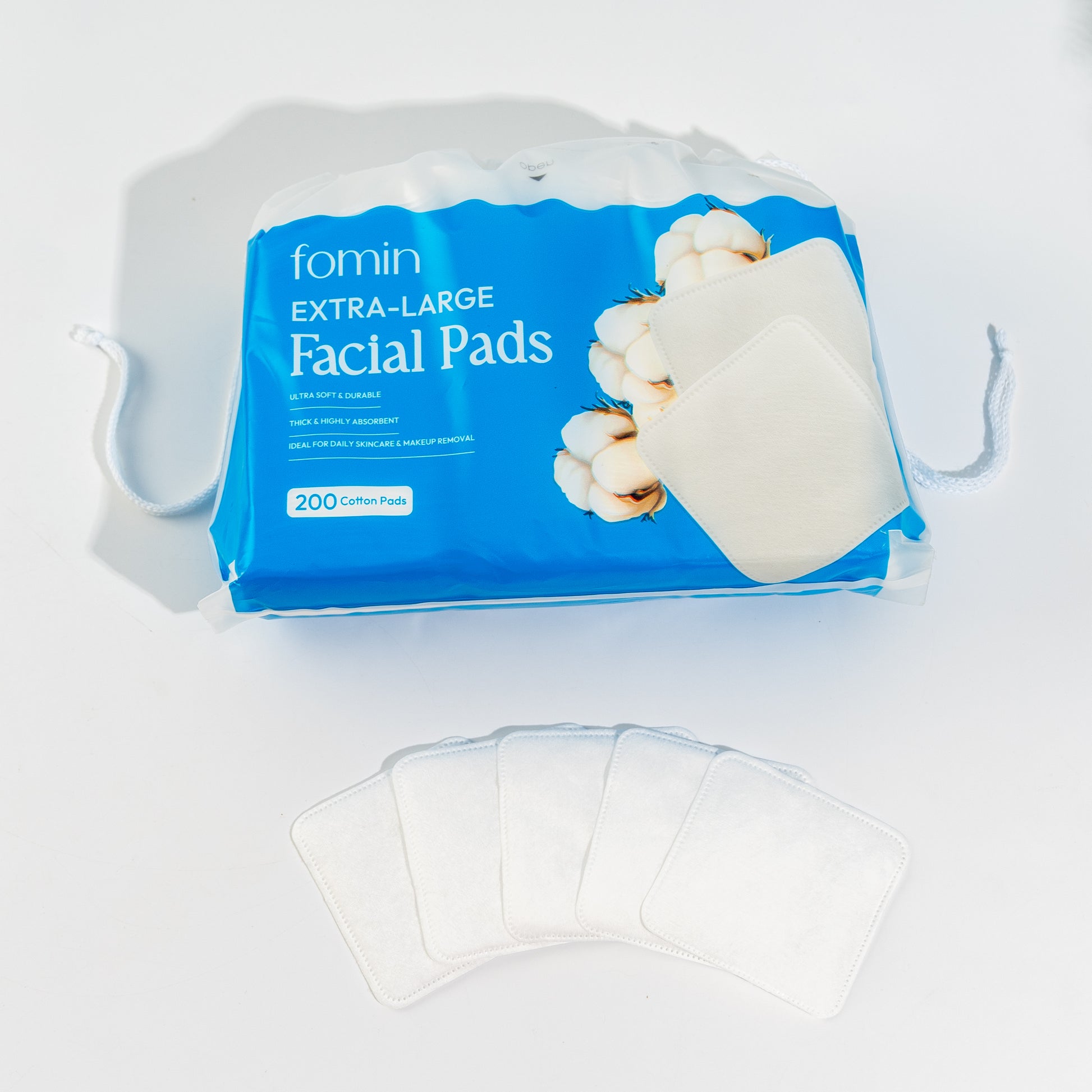 fomin Extra-Large Facial Pads packaging with a few pads displayed on a white background